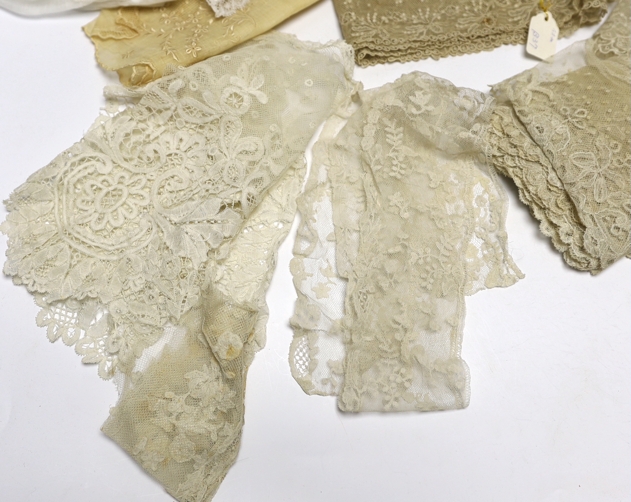 A collection of mostly 19th century French and English needle and bobbin lace trimmings, white worked sleeves, a black silk stole and black lace trimmings etc
